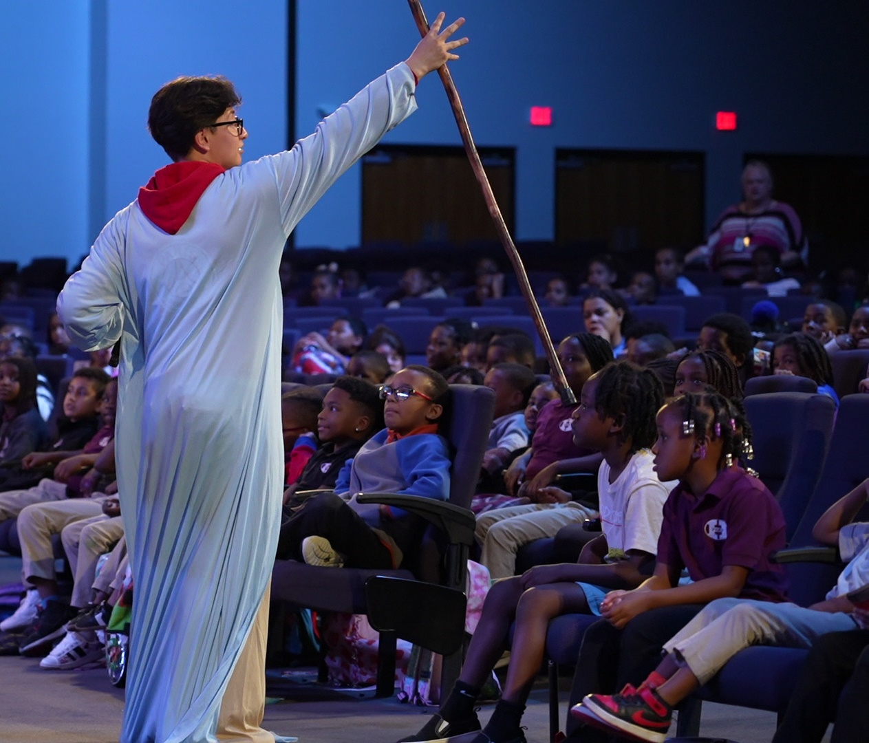 Volunteers in costume leading kids from the Sidewalk Sunday School stage