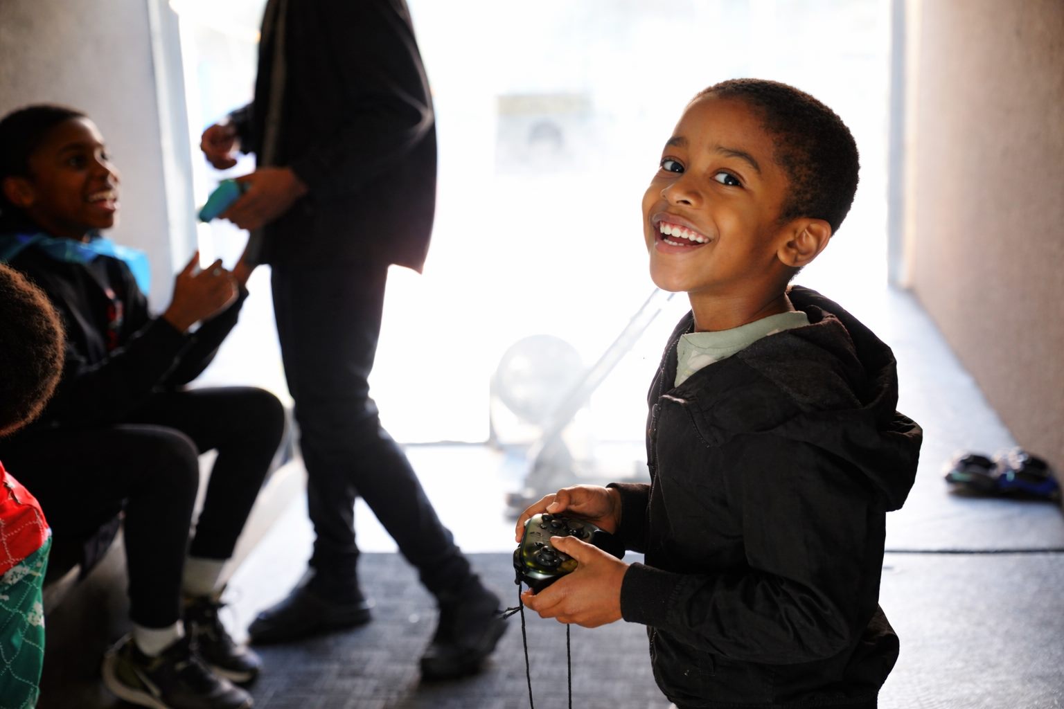 A laughing boy holding a video game controller